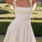 White mini dress with lace trim to tie at back