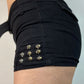 Black punk low rise denim shorts with belt and rivets