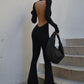 Black vintage jumpsuit with long sleeves and flared legs