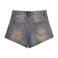 Blue vintage distressed denim shorts with washed effect