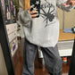 Gray punk rib knit sweater with printed spider