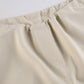Light colored baggy parachute cargo pants with drawstring and low waist