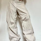 Light colored baggy parachute cargo pants with drawstring and low waist