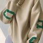 Oversized varsity sweatshirt with green letter graphic