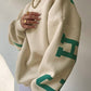 Oversized varsity sweatshirt with green letter graphic