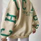 Oversized varsity sweatshirt with green letter graphic